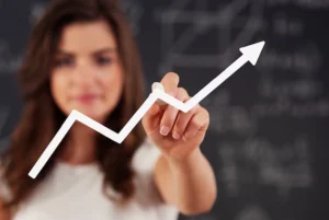 Hand holding recycle sign during sunset