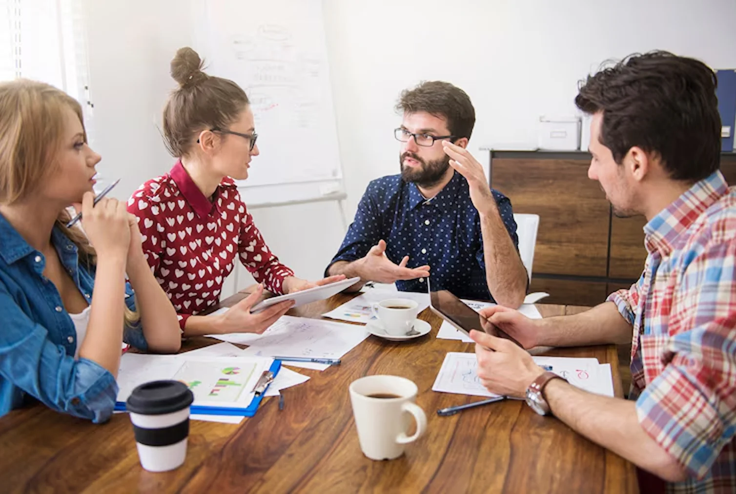 Team brainstorming around table in office
