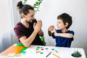 Father and son learning together with high-five