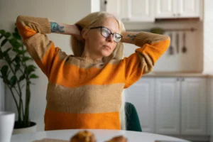 Woman stretching while working on laptop
